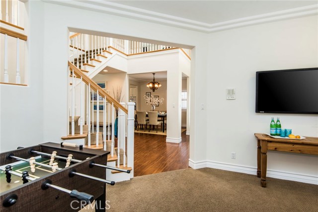 Bonus room into grand foyer, flooded with natural light from 2 story ceilings, skylights, and entry atrium window.