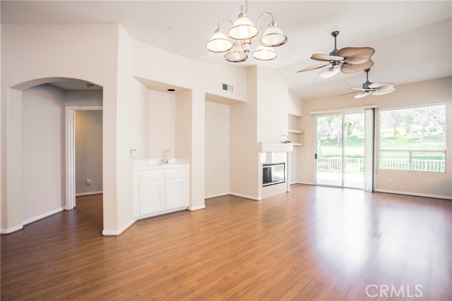 Enjoy the wet bar, media niche, shelving and raised hearth fireplace next to a great view of the golf course