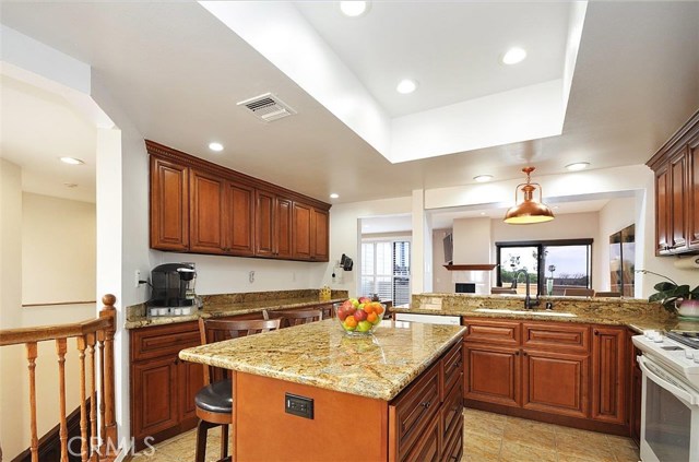 Remodeled Kitchen with Recessed Lighting and Stone Flooring