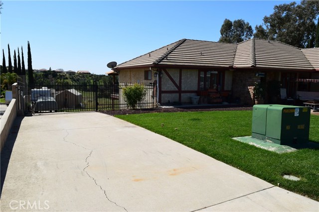 Long Concrete Driveway at left of home with Gated RV Parking