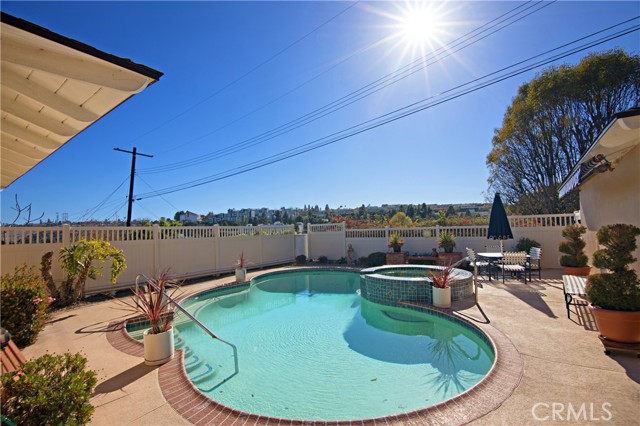 Pool. spa area surrounded by vinyl fence