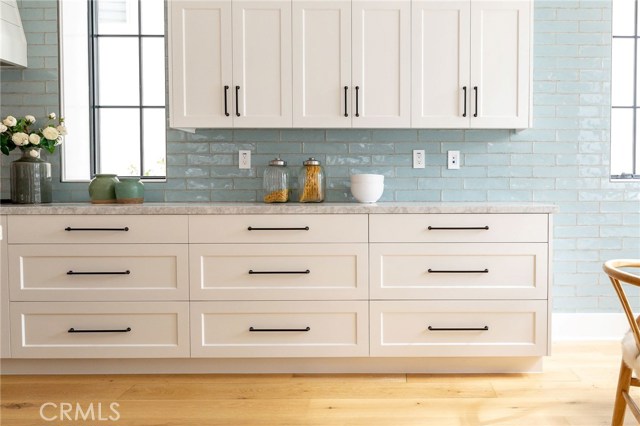 Gorgeous backsplash robin's egg blue with full marble slab counters. Cabinetry has self closing drawers