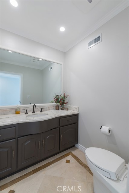 Lovely downstairs half bath has pretty marble counter tops.
