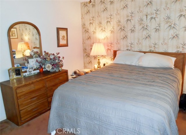 Another Angle to show that the room is spacious to hold a Large Bed, Night Stand and a Full Dresser with Mirror.