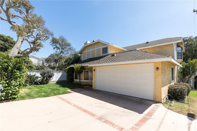 Large driveway provides 2 parking spots in addition to the 2-car garage.