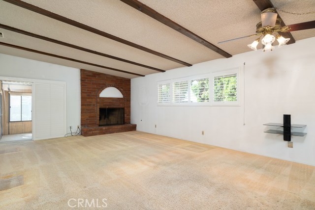 Family room and dining area share the fireplace. This is a bright, sunny room and you can see the patio room at the left of the picture. Imagine this room opening to the backyard, deck or patio through French doors.