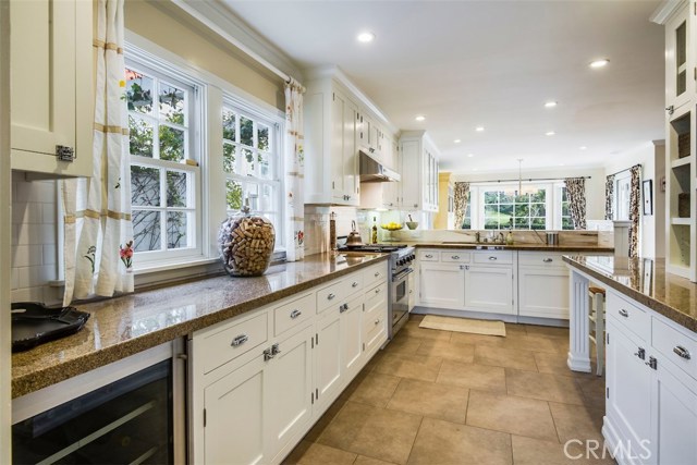 The kitchen is top shelf with granite counters, wine cooler, Viking stove/oven, built-in SubZero refrigerator, appliance garage, pantry, and tons of cabinets, as you can see.