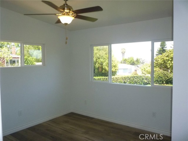 Bedroom 1 with ceiling fan and master bathroom.  One of two master bedrooms.