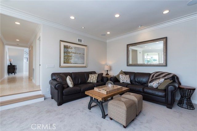Another view of the family room with hallway leading to the entry area.