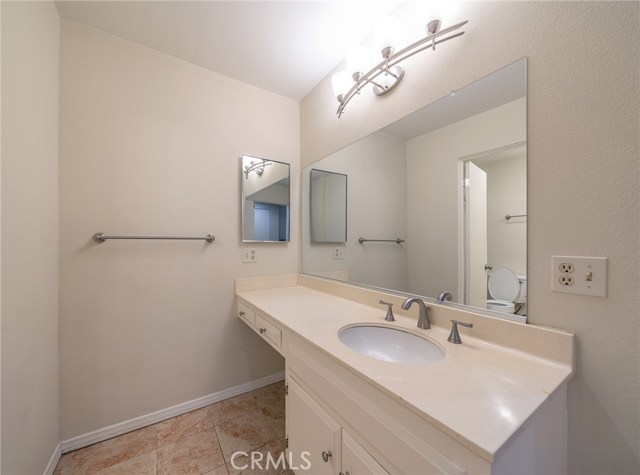 Master suite bathroom also offers a seating area on the side of the first vanity.