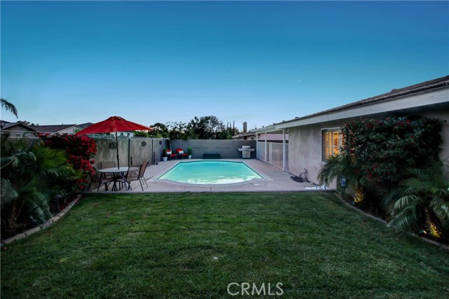 There's plenty of room in this beautiful backyard for splashing in the pool or relaxing on the lawn.  The block walls are finished in stucco and not only give privacy to this backyard, but dress it up quite a bit too.