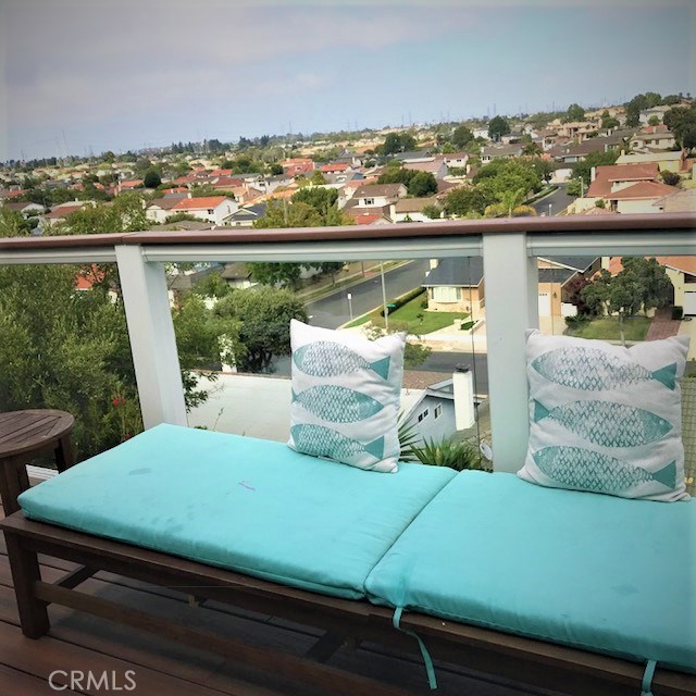 glass panel balcony with lovely view of hills and enchanting sunset