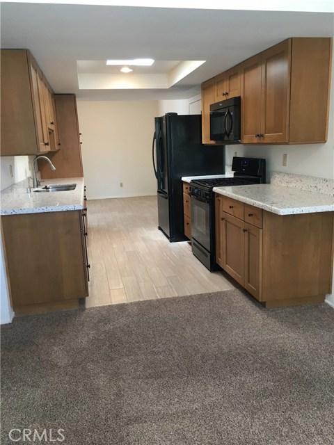 Looking into remodeled kitchen and bonus room beyond from dining area