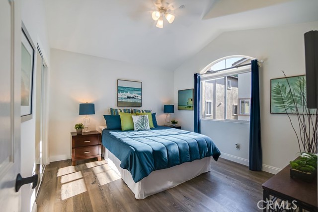 Bedroom one has vaulted ceilings, ceiling fan and mirrored closet doors.