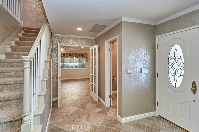 Front door and stairway up to all 4 bedrooms.