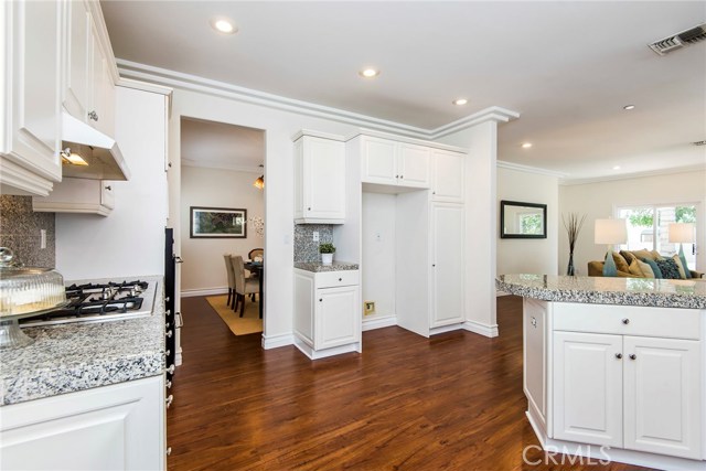 Corner of kitchen view into dining room and family room.  Space enough for large french door refrigerator.