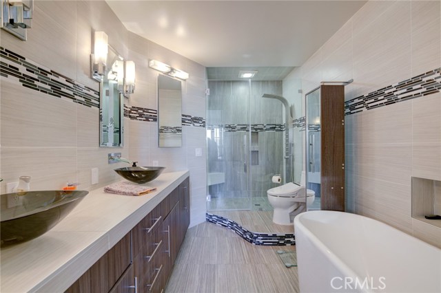 Primary ensuite bath with free-standing bathtub and separate shower.