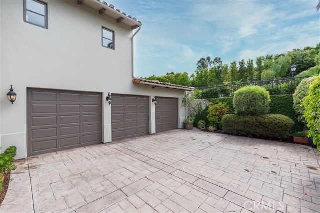 3 car garage.  Lush area above is the big raised pool area!!!