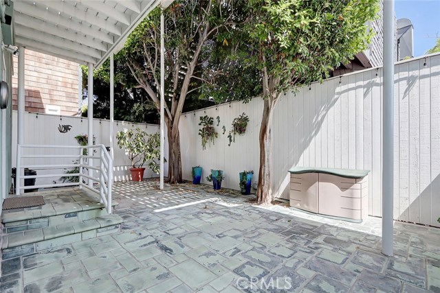 private backyard patio with trees providing shade