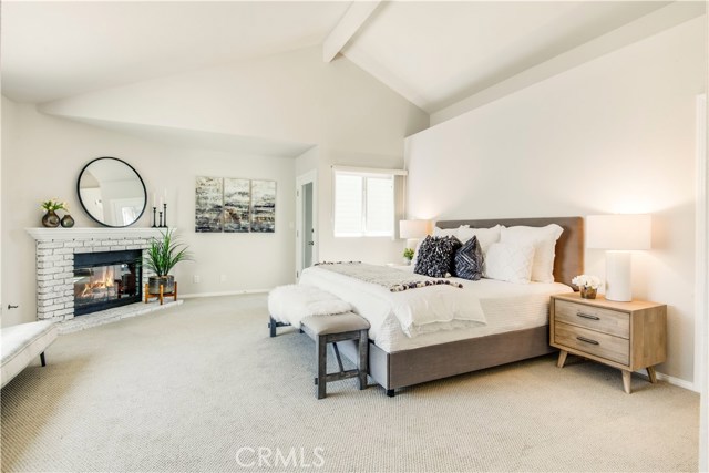 Sumptuous, en suite main bedroom with whitewashed brick, gas fireplace and private deck.