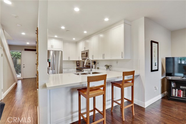 Breakfast/ bar and hallway to front door. Good view of brand new floors