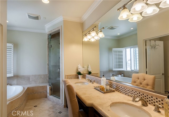 The master bath features dual sinks, a spa tub and separate shower.