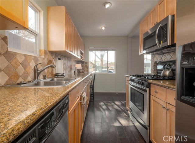 Kitchen looking back toward front of the house, recessed lights and great natural light streaming in from the window.
