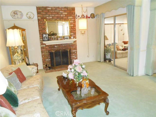 Formal Living Room also leads you a Glass Sliding Door onto Step-Down Enclosed Patio/Family Room/Den.