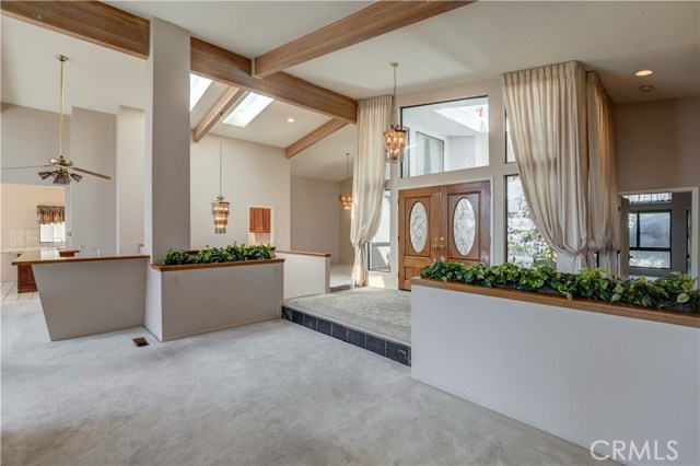 A view from one of the living rooms toward the kitchen on the left, formal dining room straight ahead and in-law suite plus extra half bathroom for guests to the right.