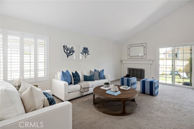 View of the living room from the entry/foyer. The windows were upgraded with plantation shutters.