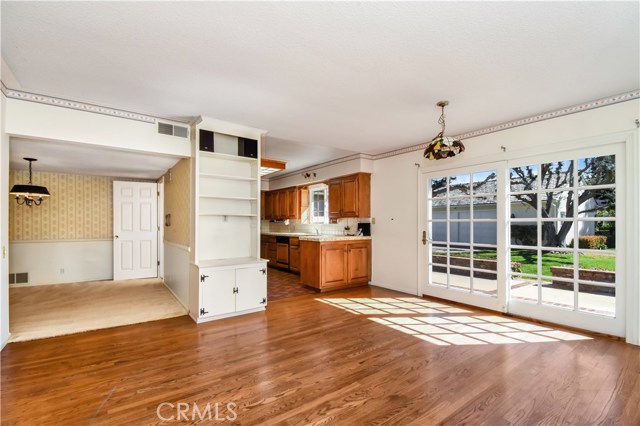 Family room is open to formal dining room, kitchen, and backyard