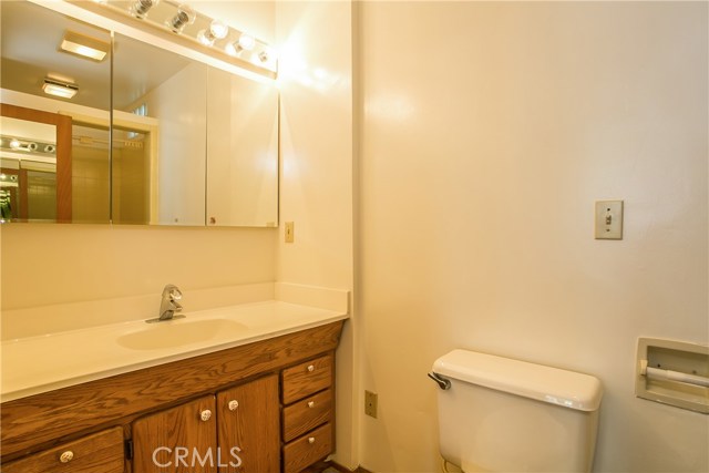 The master bathroom has a well sized wooden vanity and a tiled shower