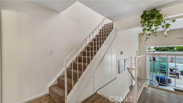 Stairway to upstairs with sizable storage cabinets under the stairway.