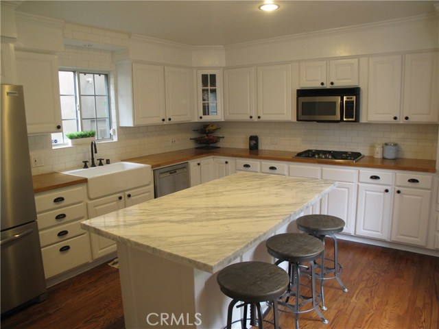 Remodeled kitchen with Carrera marble and an island for casual eating.