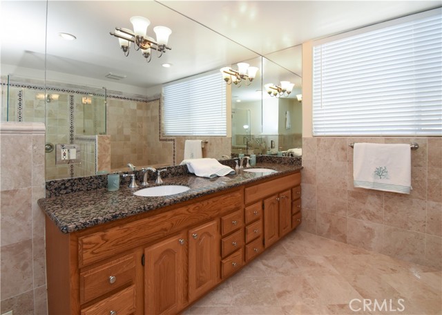 Beautiful cabinets and counters and wall of mirror in the master bath