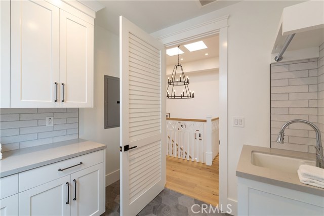 Laundry room with set up for two stackable washer and dryers