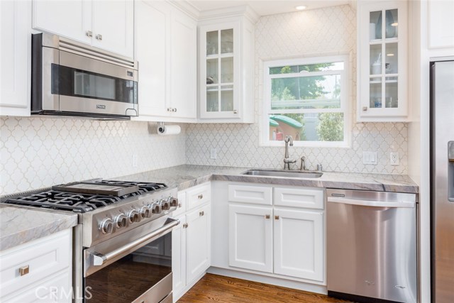 Viking 5-burner stove with griddle center, Viking microwave, and a sunny window to check out the goings on!