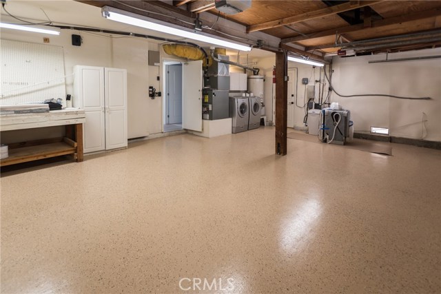 3 car garage with work area, washer/dryer and painted floor