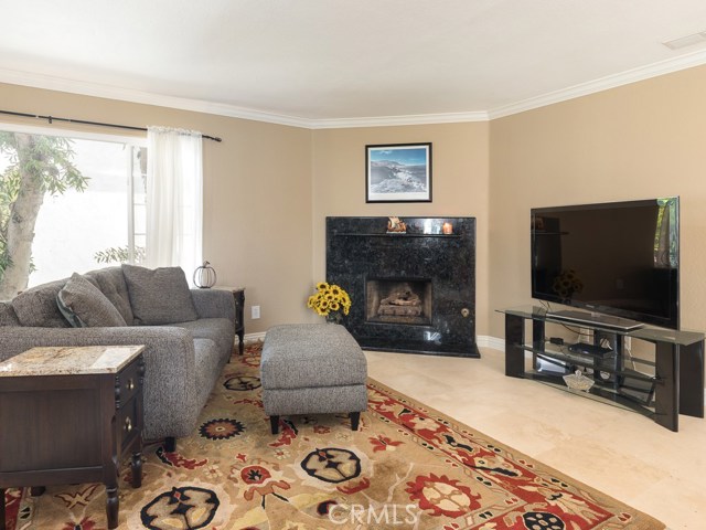 Living room fireplace has been upgraded with a gorgeous Volga Blue granite surround!