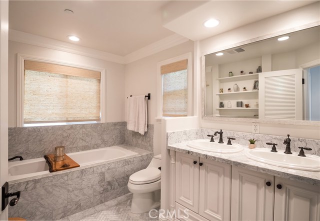 Master bathroom with spa tub, double sinks, walk in shower