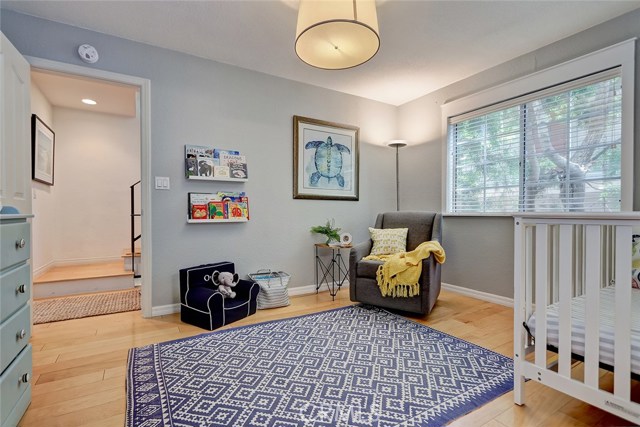 Highlighted features include maple hardwood floors, custom window treatment and light fixture.