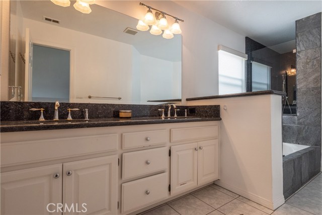 Master bath with dual vanities, deep bath tub, separate shower