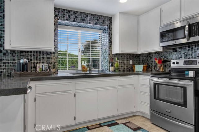 Kitchen has quartz counter tops and stainless appliances.