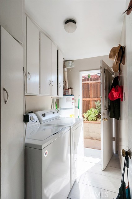 Laundry room has tile floors and door to side. Front unit.  Laundry room in a 2 bedroom rental?  Wow!