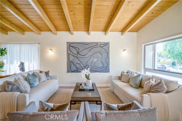 Just one area in the open floor plan of this inviting living room. Light fills the room, ceilings soaring, peaceful and practical use of space everywhere so you can live your beach life your way.