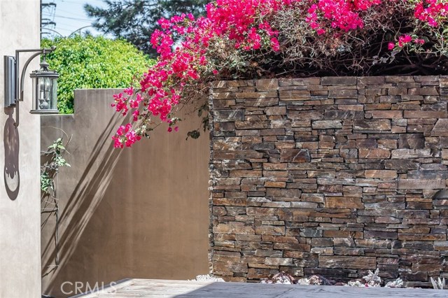 New hand-laid stone wall above outdoor fireplace