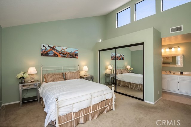 Master Bedroom #1 with mirrored closet doors and large windows providing lots of natural light!