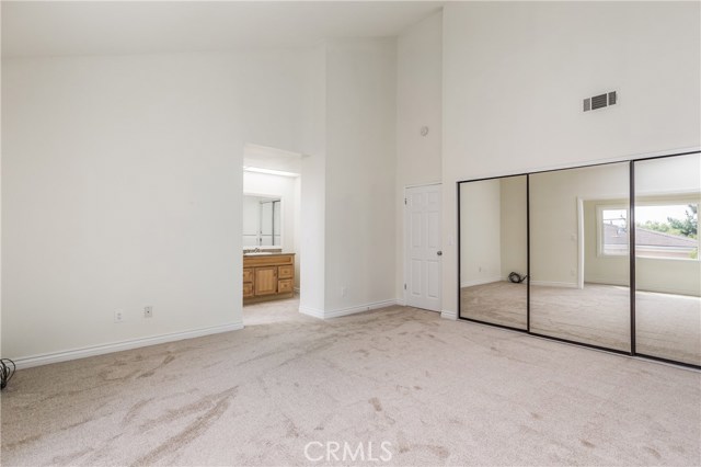 Master Bedroom with vaulted ceiling, large closet and entrance to bathroom