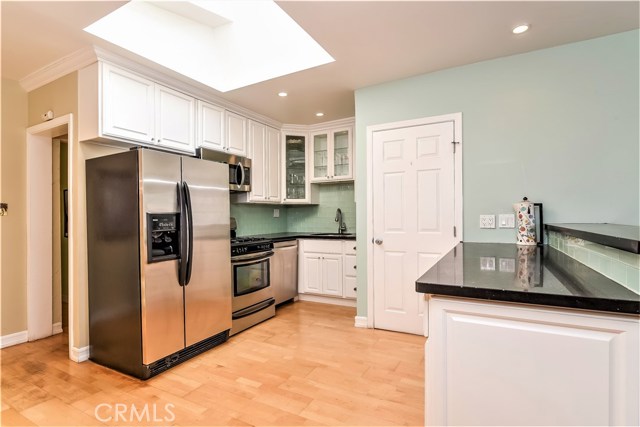 The remodeled kitchen as ample storange and new stainless appliances. The large overhead skylight is positioned over the work areas.