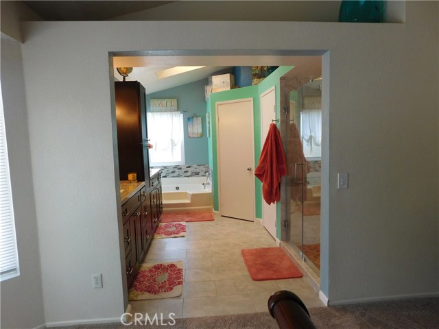 Master bathroom, tub, shower,cabinets walk in closet and private toilet room as viewed from master bedroom